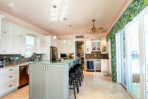 A kitchen with a large island and a refrigerator.